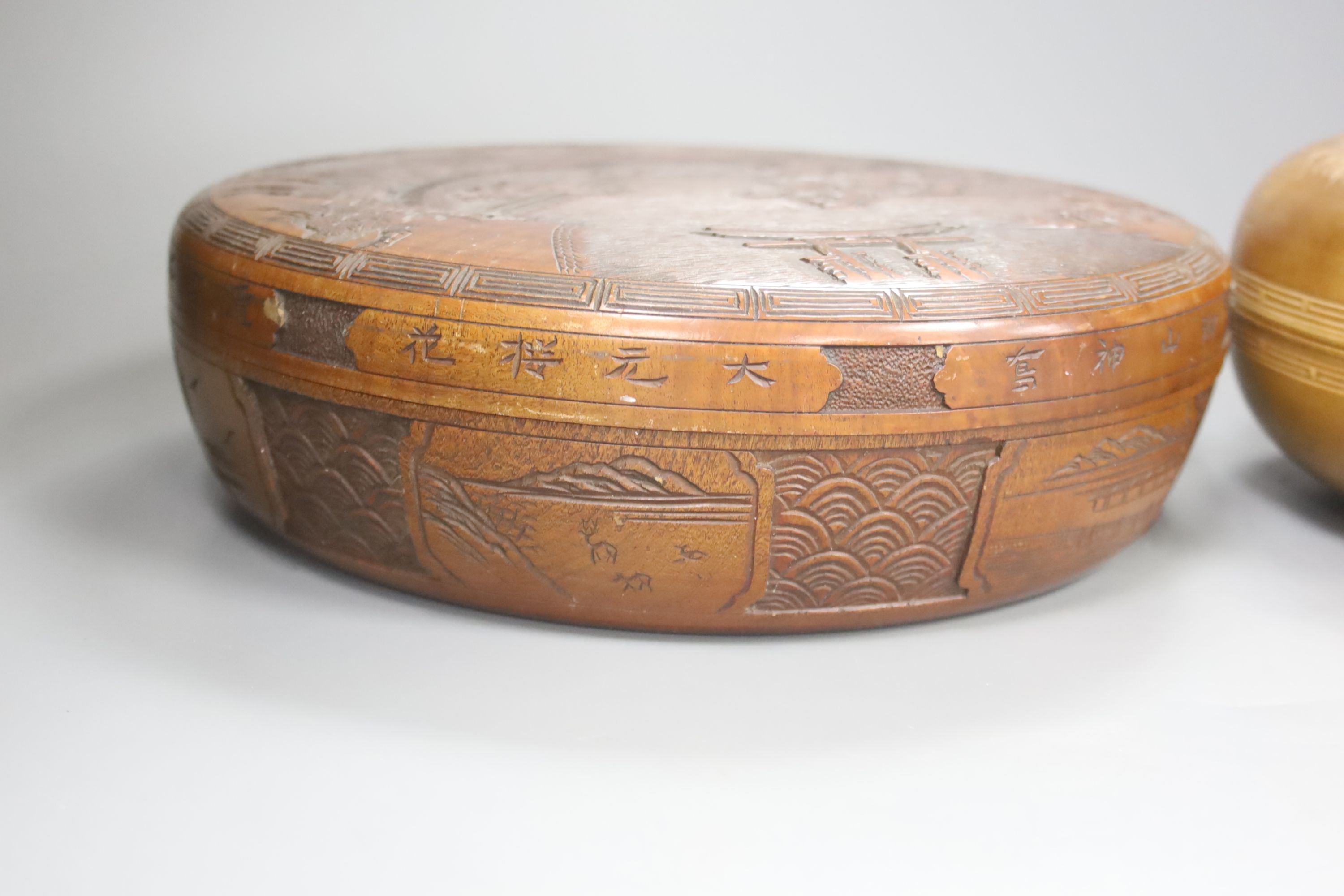 Two Japanese shallow carved wood circular lidded boxes, largest 27cm diameter